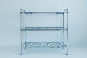 Sleek metal shelving unit against a minimalist backdrop in a well-lit interior space photo