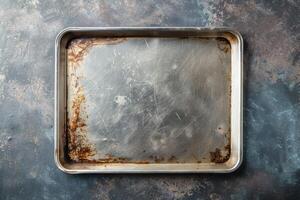 A well-used baking tray rests on a rustic countertop after countless delicious creations in a cozy kitchen photo