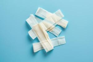 A collection of assorted bandages arranged playfully on a soft blue background, inviting healing and comfort photo