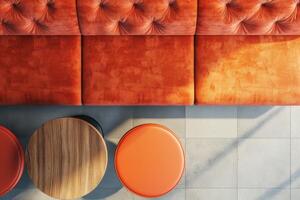Cozy seating arrangement with vibrant orange cushions in a modern cafe during afternoon light photo