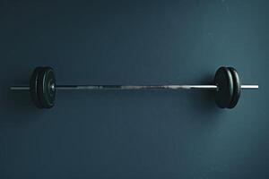 A heavy barbell resting on a blue background, awaiting the next workout session at dawn photo