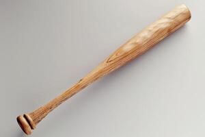 A polished wooden baseball bat rests elegantly on a smooth surface in soft light, showcasing its craftsmanship and timeless design photo