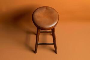 A rustic wooden stool stands on a warm, golden background, inviting a moment of pause in a cozy, minimalist space photo
