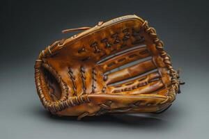 A well-worn baseball glove resting on a dark surface, capturing the essence of the game and memories it holds photo