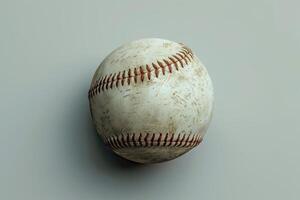 A weathered baseball resting on a smooth surface, capturing the essence of countless games played under the sun photo