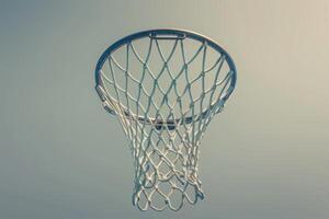 A sunlit basketball hoop against a clear blue sky, inviting a game of skill and teamwork beneath the warm afternoon glow photo