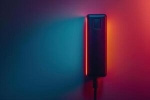 A sleek power bank illuminated by vibrant red and blue lighting against a minimalist background in a dimly lit space photo