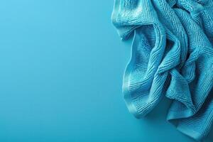 Soft turquoise cloth draped elegantly on a vivid blue background, highlighting texture and color harmony in a minimalist setting photo