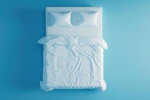 Tranquil bedroom with neatly arranged white bedding against a serene blue backdrop photo