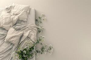 Soft bedding adorned with delicate flowers arranged artistically in a serene bedroom setting during daylight photo