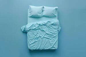 Light blue bedding arrangement with crumpled sheets in a serene bedroom on a quiet afternoon photo