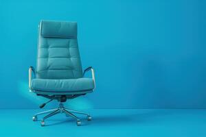 A modern teal office chair stands out against a vibrant blue wall in a minimalist workspace photo