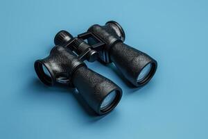 Exploring distant horizons with classic binoculars on a vibrant blue backdrop photo