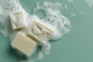 Bubbles and bars artisanal soap resting on a serene green surface with gentle foam photo