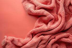 Cozy morning vibes featuring a soft coral blanket on a textured pink background in a warm, inviting setting photo