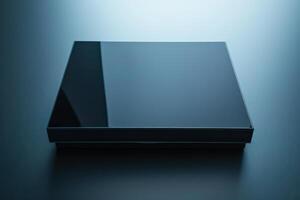 Glossy black square-shaped object resting on a textured surface illuminated by soft ambient light during twilight photo