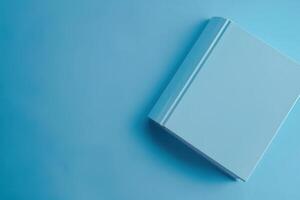 A minimalistic blue book resting on a smooth surface, inviting curiosity and imagination photo