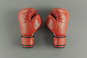 Red boxing gloves resting on a smooth surface, ready for an intense training session at a local gym photo