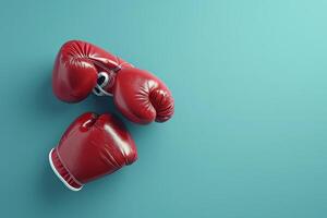 Bright red boxing gloves resting on a teal surface at a sports training facility photo