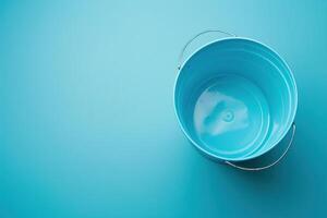 A serene turquoise bucket resting on a matching surface, embodying simplicity and tranquility in a minimalist setting photo