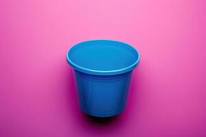 A vibrant blue container stands against a playful pink backdrop, inviting creativity and imagination photo