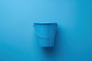 Vibrant blue bucket against a striking azure wall, capturing simplicity and color harmony in a minimalist setting photo