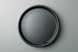 Elegant black tray against a minimalist gray wall, embodying simplicity and modern design in a serene interior space photo