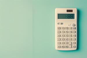 A vintage calculator displaying numbers on a pastel green wall in a cozy workspace setting photo