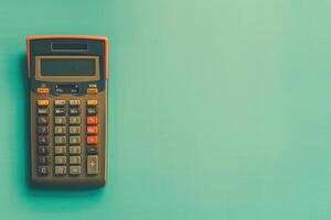 A vintage calculator rests on a pastel green table, evoking nostalgia and simplicity in everyday math tasks photo