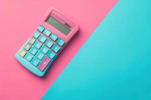 A vibrant pink and blue calculator placed on a colorful background suited for artistic workspace setups photo