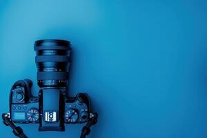 A creative composition of a DSLR camera resting on a vibrant blue background, showcasing the intricate design and sleek technology of modern photography photo