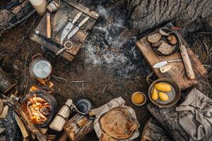 Cozy campfire cooking experience in the forest with handcrafted meals and rustic tools photo