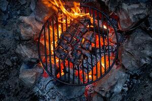 Grilling delicious steaks over an open fire during a summer evening cookout photo