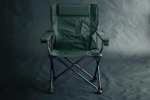 A solitary camping chair stands in a dimly lit space, ready for a relaxed outdoor gathering under the stars photo