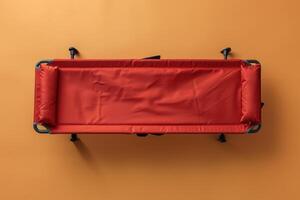 Bright orange backdrop highlights an empty stretcher, awaiting use, symbolizing readiness for emergencies and healthcare support photo