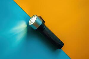 A sleek flashlight illuminating a vibrant split background of blue and orange colors photo