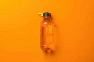 A vibrant orange bottle of refreshing drink rests on a bright orange backdrop, capturing the essence of summer refreshment in a minimalist setting photo