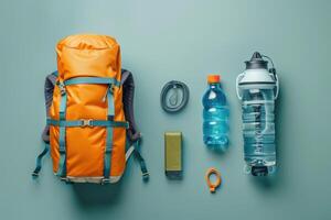 Essential hiking gear arranged on a teal surface for an adventurous journey into nature photo