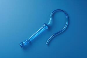 A striking glass hookah pipe illuminated in vibrant blue tones against a sleek surface at dusk photo