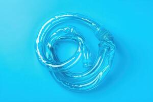 A spiraled transparent hose on a vibrant blue background, showcasing its flexible structure and reflective surface, capturing a playful yet intriguing aesthetic photo