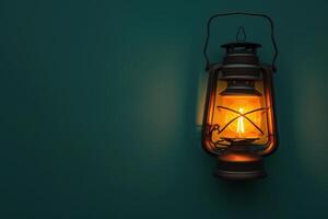 Warm glow of a vintage lantern illuminating a teal wall at dusk photo