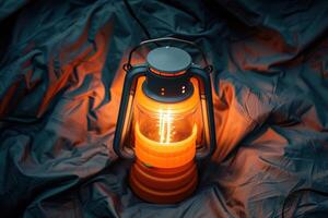 A glowing lantern illuminates a cozy campsite under a starry sky at dusk, inviting warmth and adventure photo