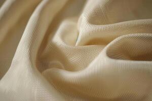 Soft beige fabric draping elegantly under warm light in a cozy setting photo