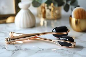 Elegant facial rollers on a marble countertop with decorative elements in the background photo