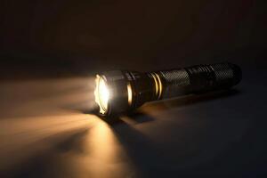 Bright flashlight illuminating a dark surface in a dimly lit indoor environment photo