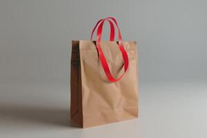 Simple brown paper bag with red handles on a neutral background photo