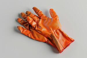 Orange rubber glove resting on a flat surface in a well-lit room photo