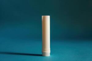 Simple white glue stick on a blue background showcasing a clean, modern workspace aesthetic photo