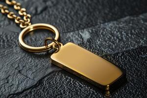 Close-up of a gold pendant with ring on textured black surface photo