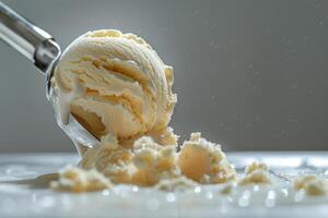 Creamy vanilla ice cream being scooped from a tub with a metal scoop in a bright kitchen photo